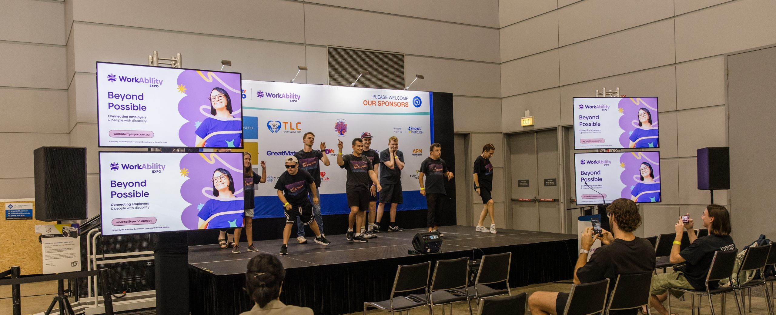 A group of people dancing on stage at WorkAbility Expo