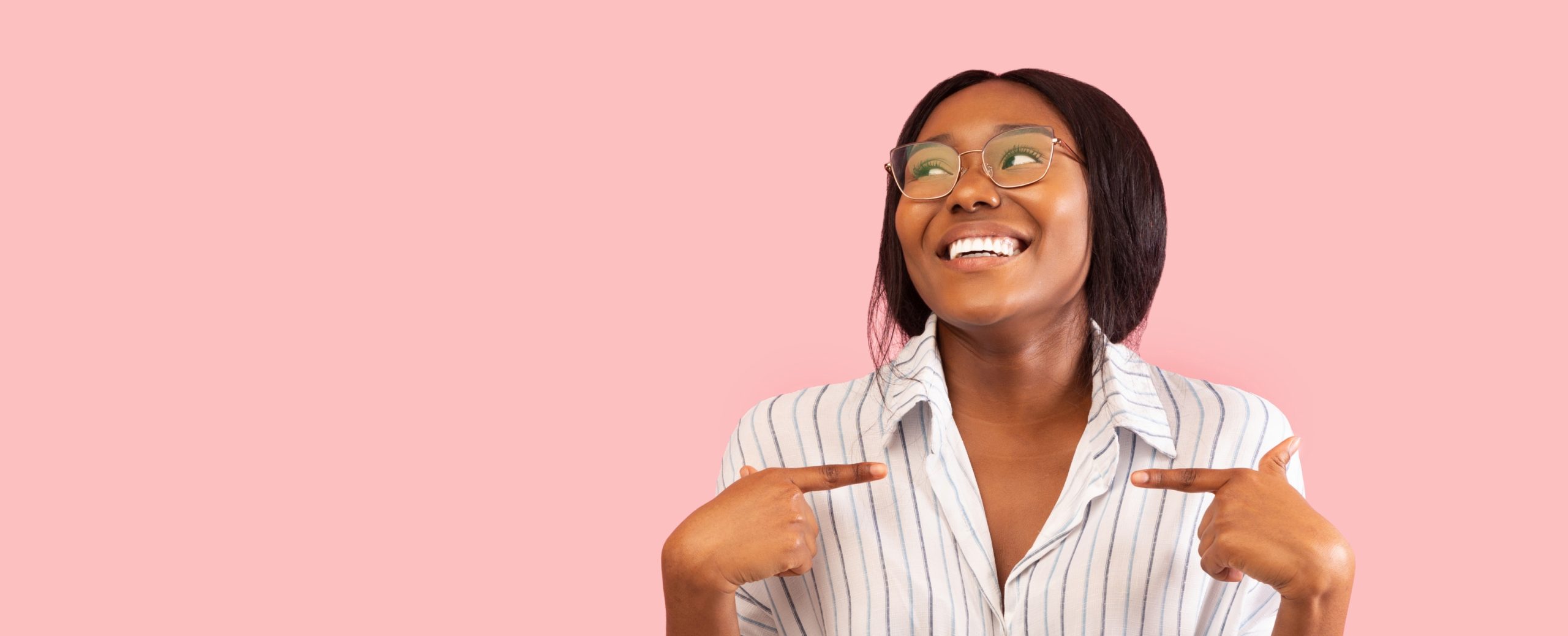 Woman Pointing Fingers At Herself Standing Over Pink Studio Background.